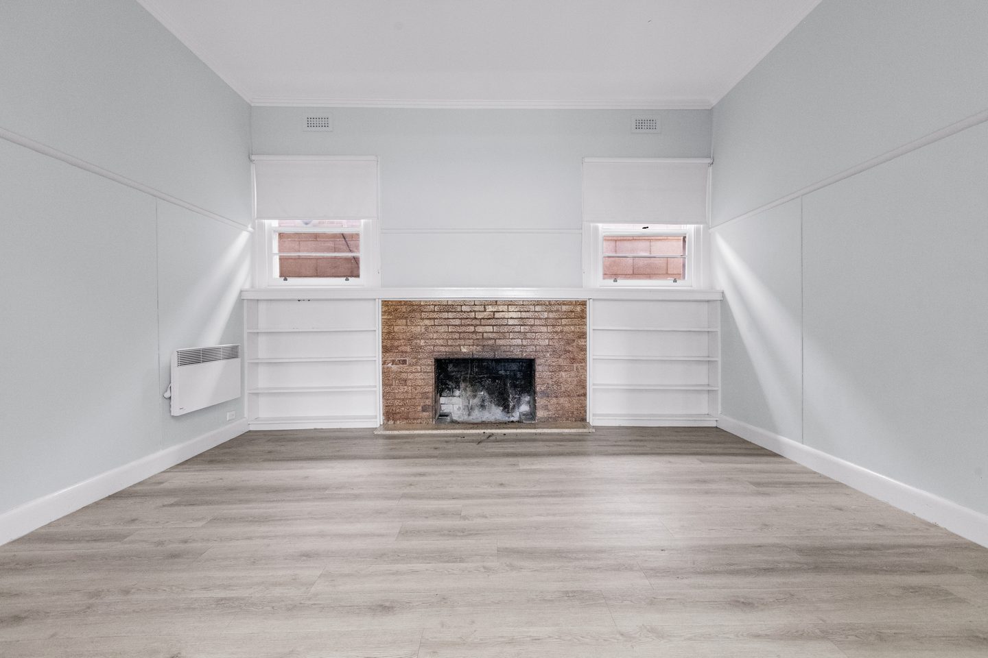 Dining room with fireplace and shelving