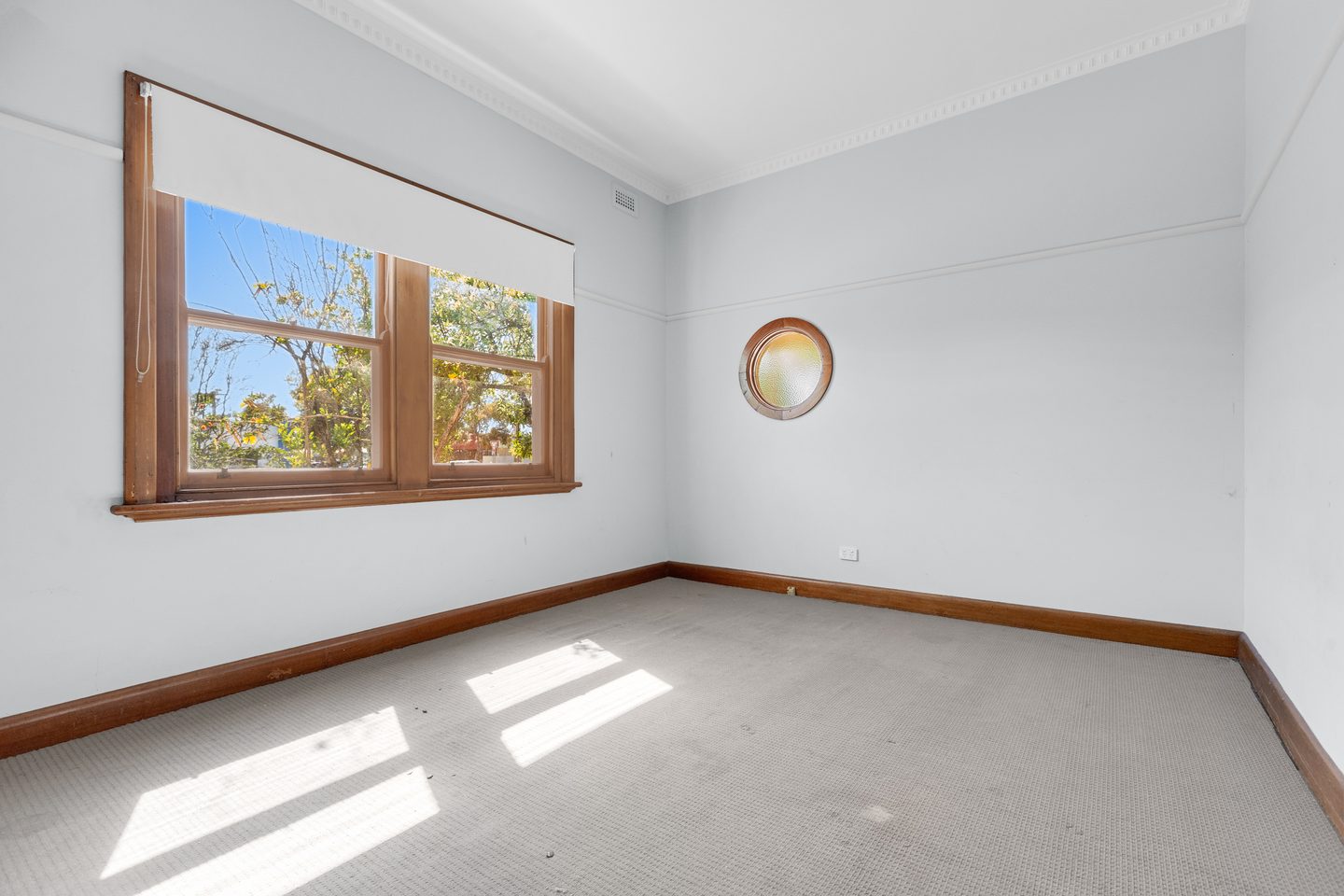 Bedroom with a round window