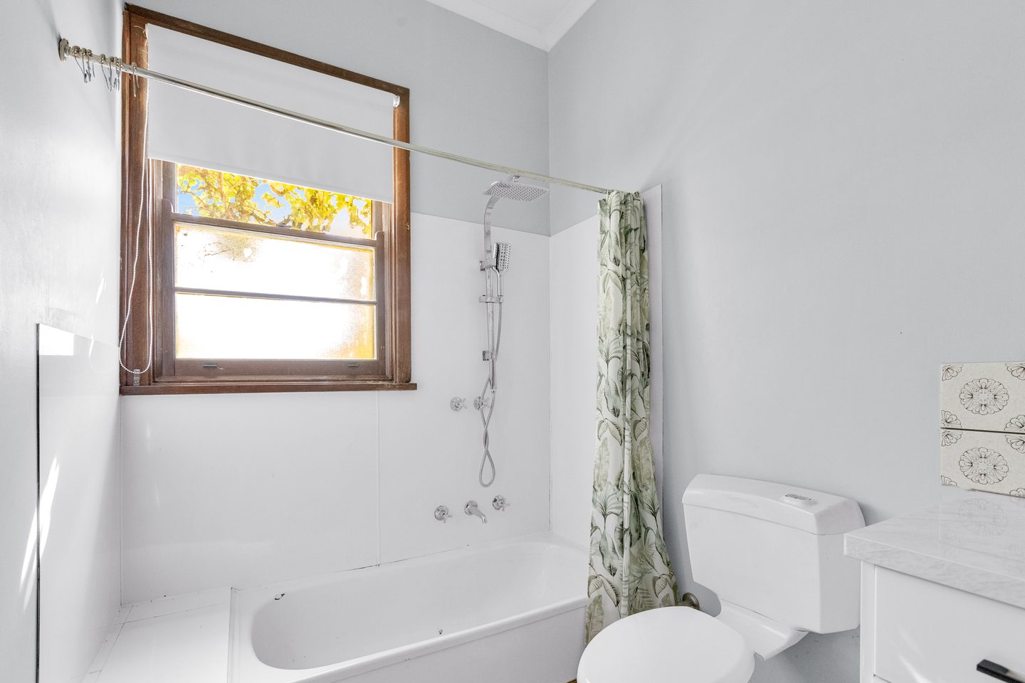 Bathroom with a bath and overhead shower