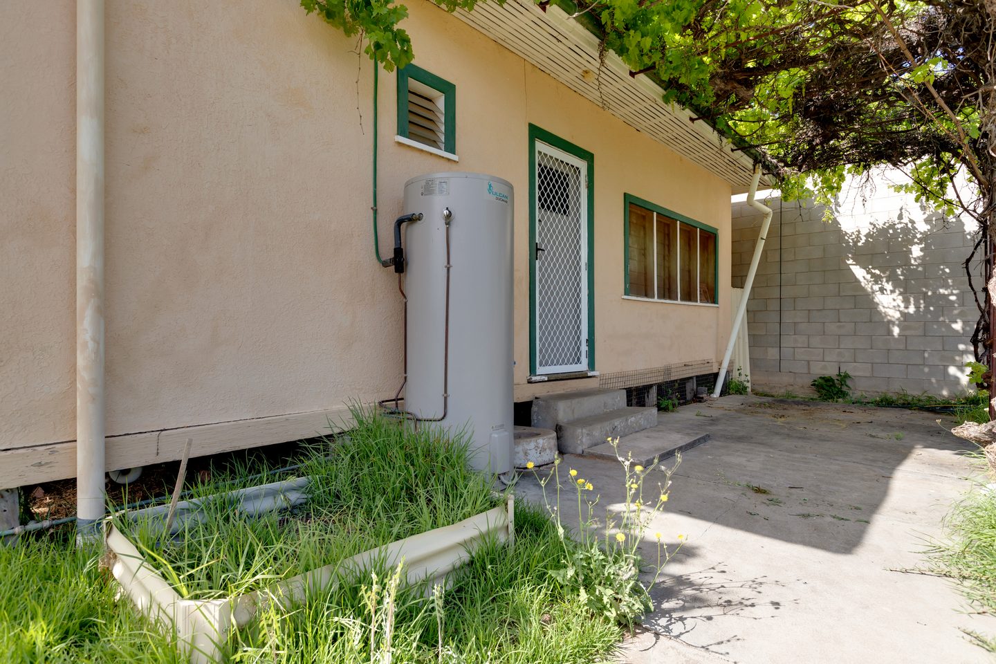 Patio beside the rear of the house